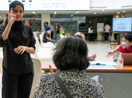 Interpreter signing on behalf of a deaf participant